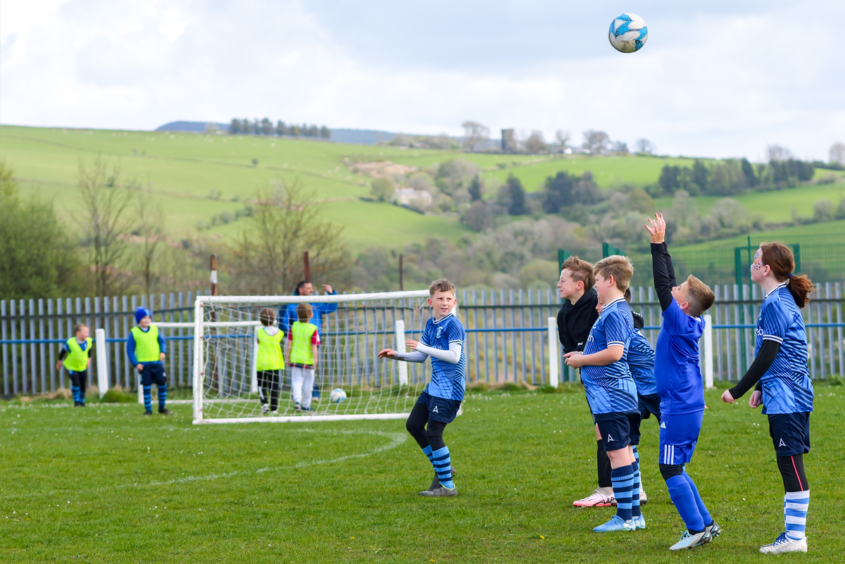 Pobl ifanc yn eu harddegau yn chwarae gêm bêl-droed 